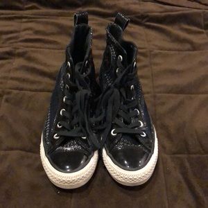 Black cloth and patent leather converse